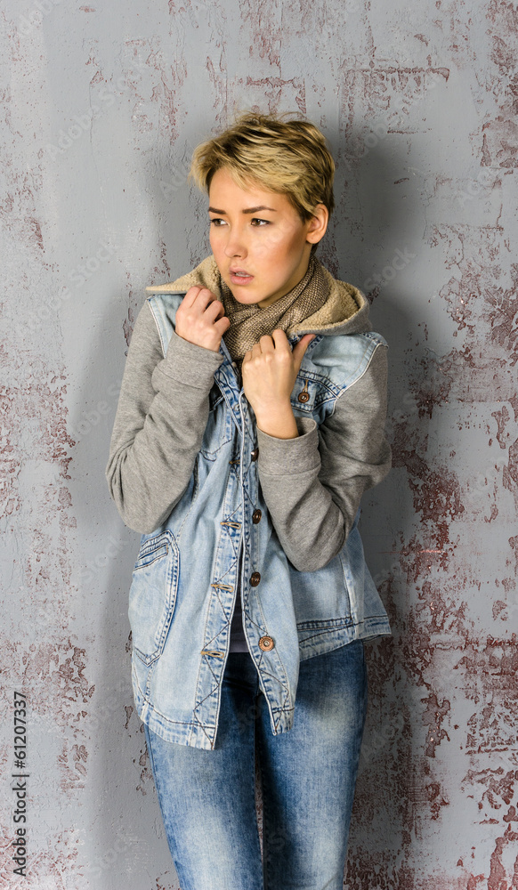 girl with short hair wearing jeans and a jacket at the wall girl with short hair wearing jeans and a jacket at the wall