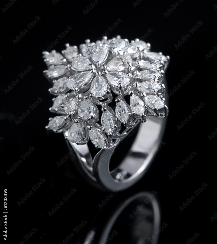 Diamond ring shot on a black reflective background Diamond ring shot on a black reflective background