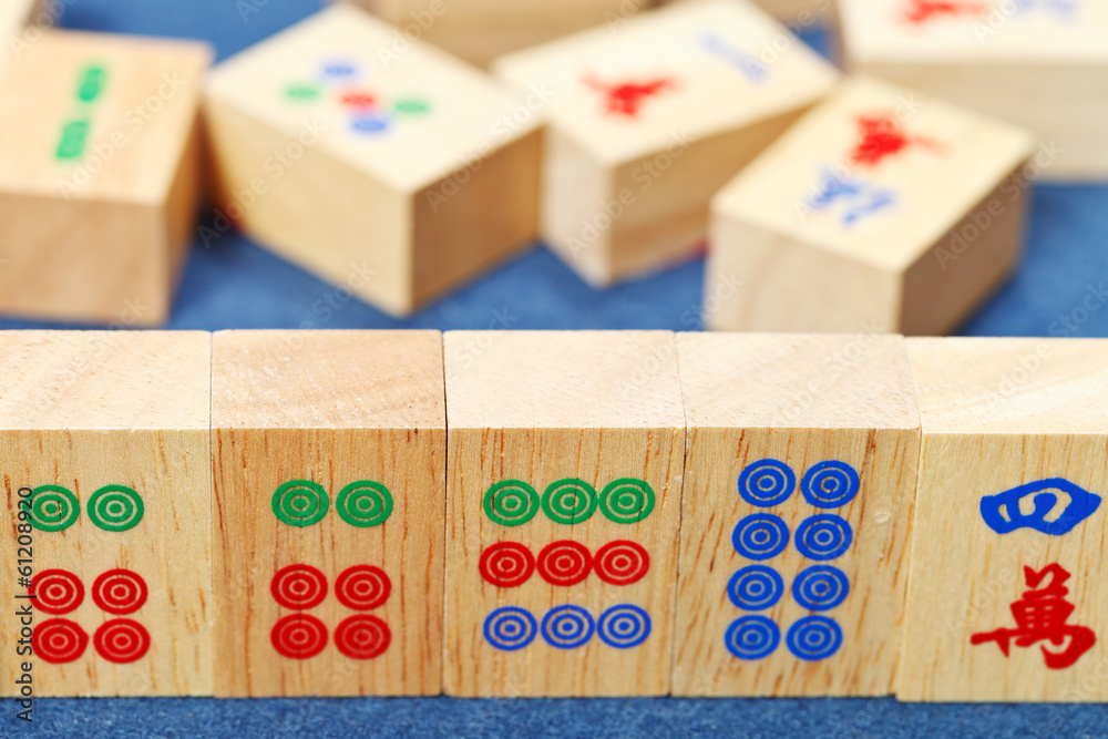 wood tiles closeup in mahjong game on blue cloth wood tiles closeup in mahjong game on blue cloth