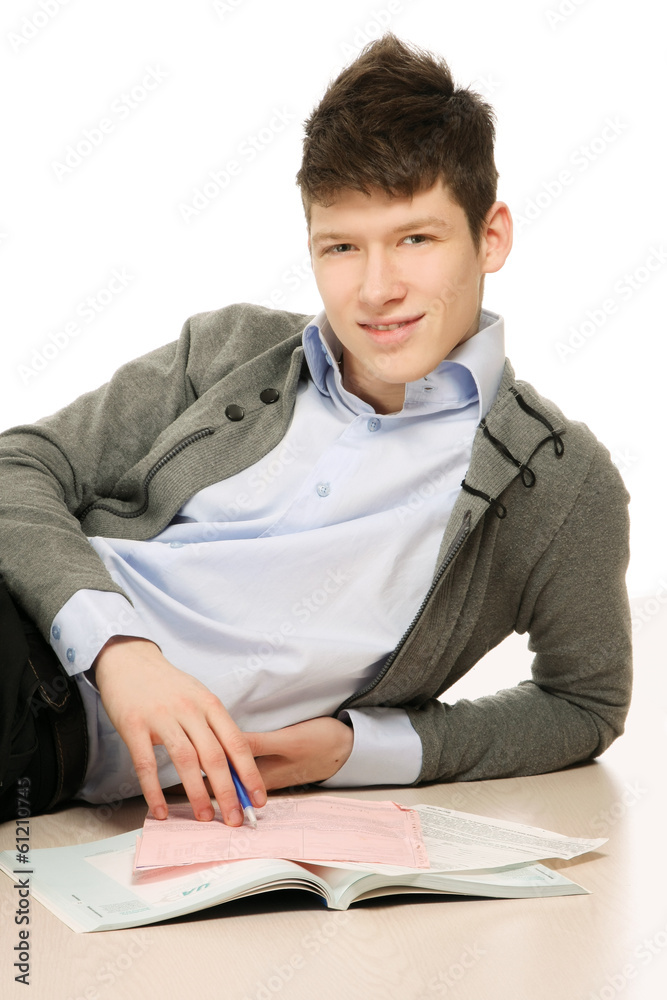 A young handsome college guy lying on the floor. A young handsome college guy lying on the floor.