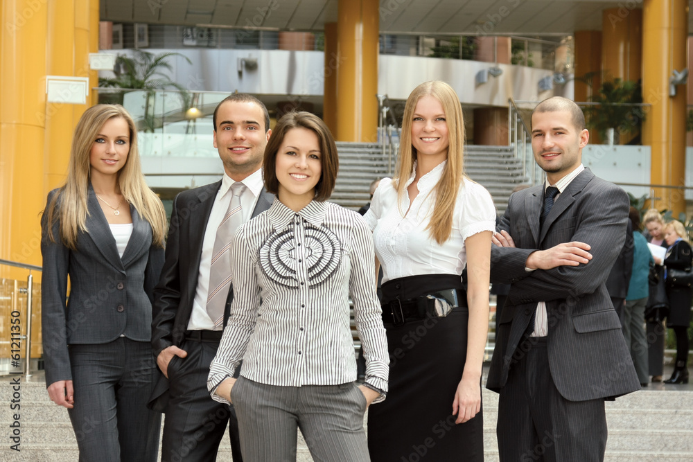 Successful business man standing with his staff Successful business man standing with his staff