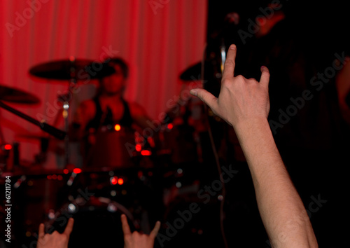 Audience at a rock concert giving the horns sign