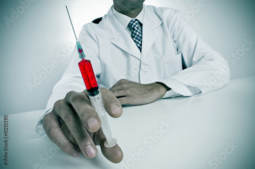 sinister doctor with a syringe photo