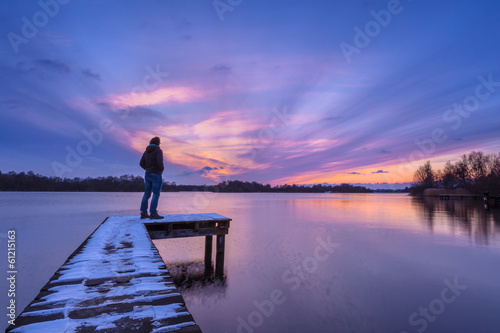 Man Watching the Sunset From a Pier photo