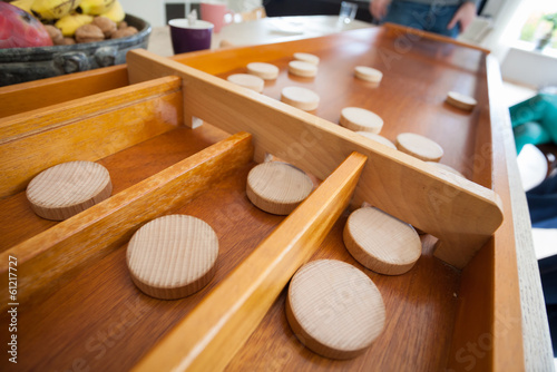 A traditional Dutch game called 'sjoelen'. The wooden disks hove photo