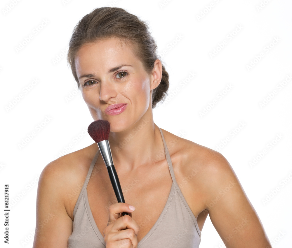 Thoughtful young woman with brush Thoughtful young woman with brush
