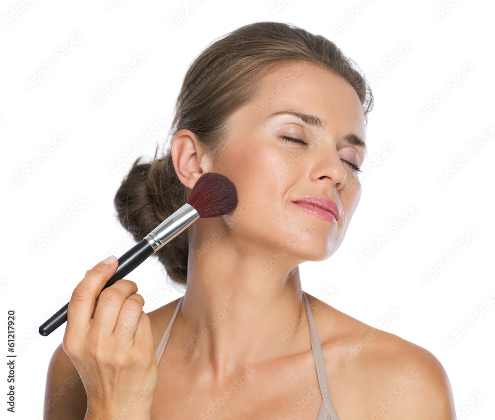 Happy young woman enjoying using brush Happy young woman enjoying using brush