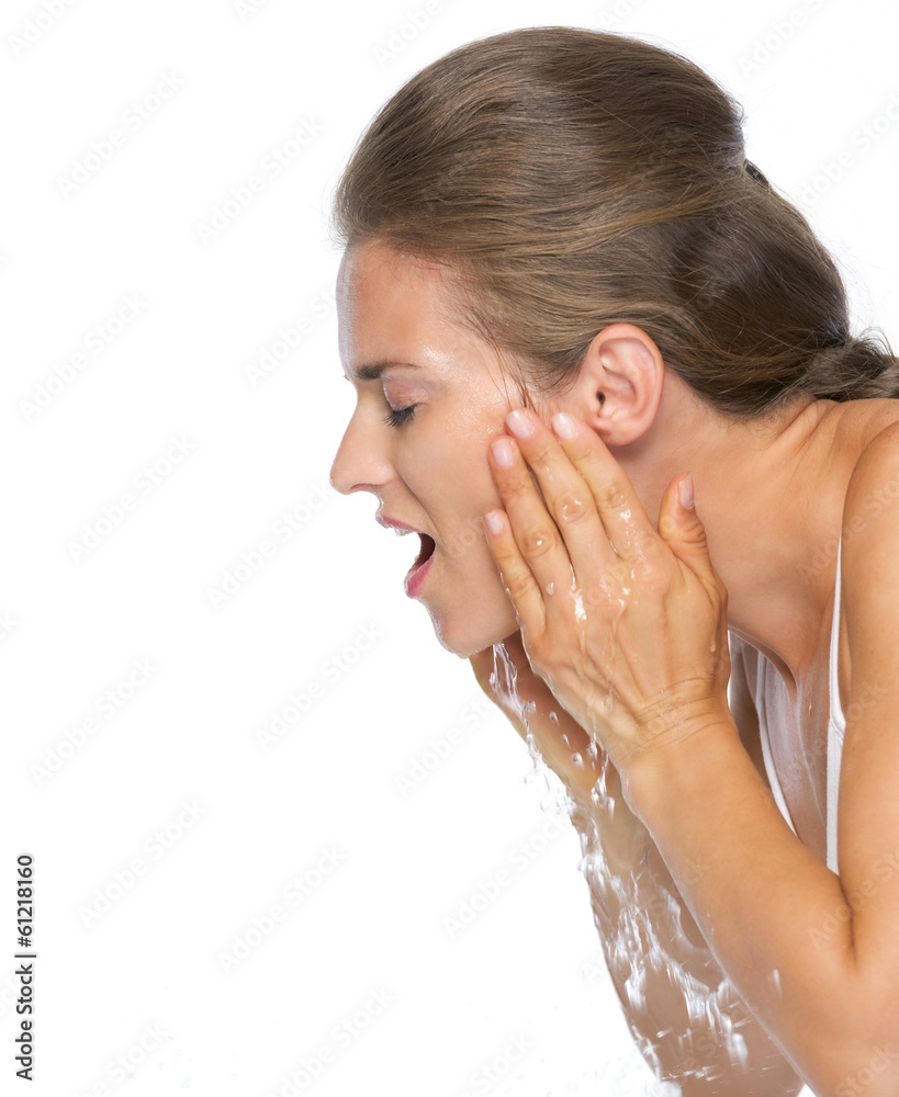 Profile portrait of young woman washing face Profile portrait of young woman washing face
