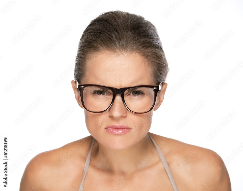 Young woman in eyeglasses looking attentively in camera Young woman in eyeglasses looking attentively in camera