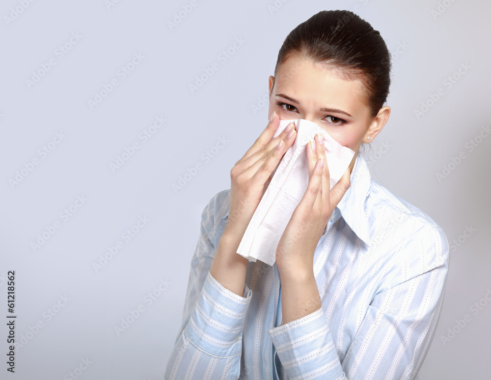 Sick woman blowing her nose, white background. Sick woman blowing her nose, white background.