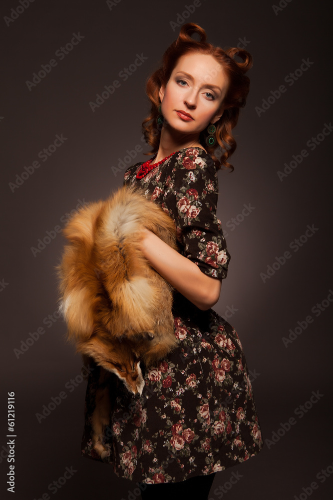 Girl in retro style posing with fur things.