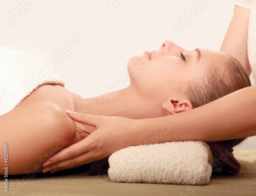 An attractive young woman receiving massage.