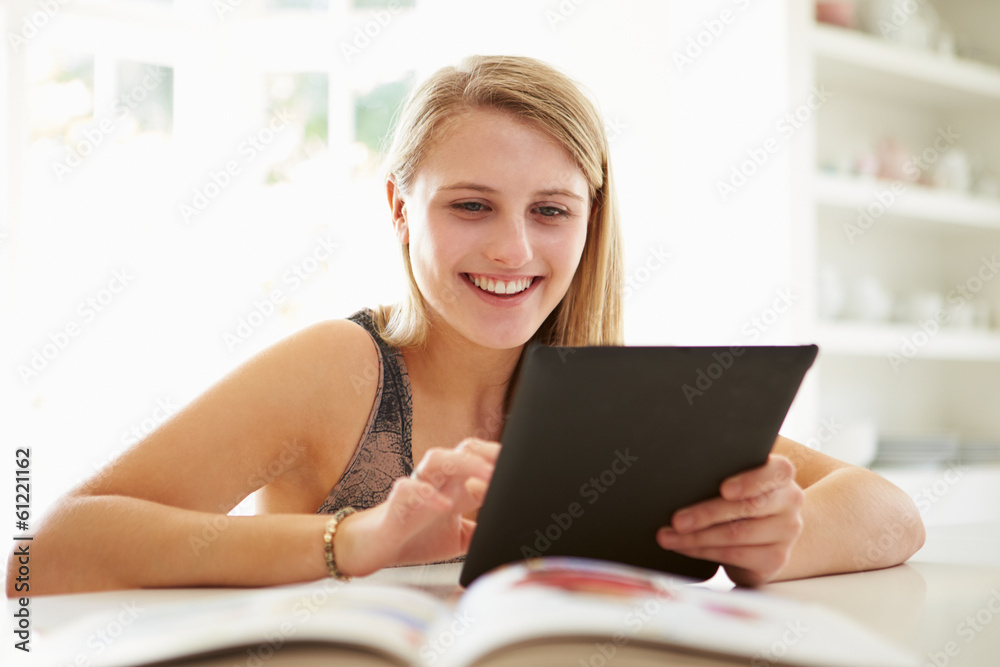 Teenage Girl Studying Using Digital Tablet At Home Teenage Girl Studying Using Digital Tablet At Home