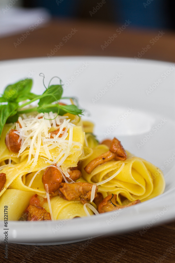 Image of pasta with chanterelle served in white dish Image of pasta with chanterelle served in white dish