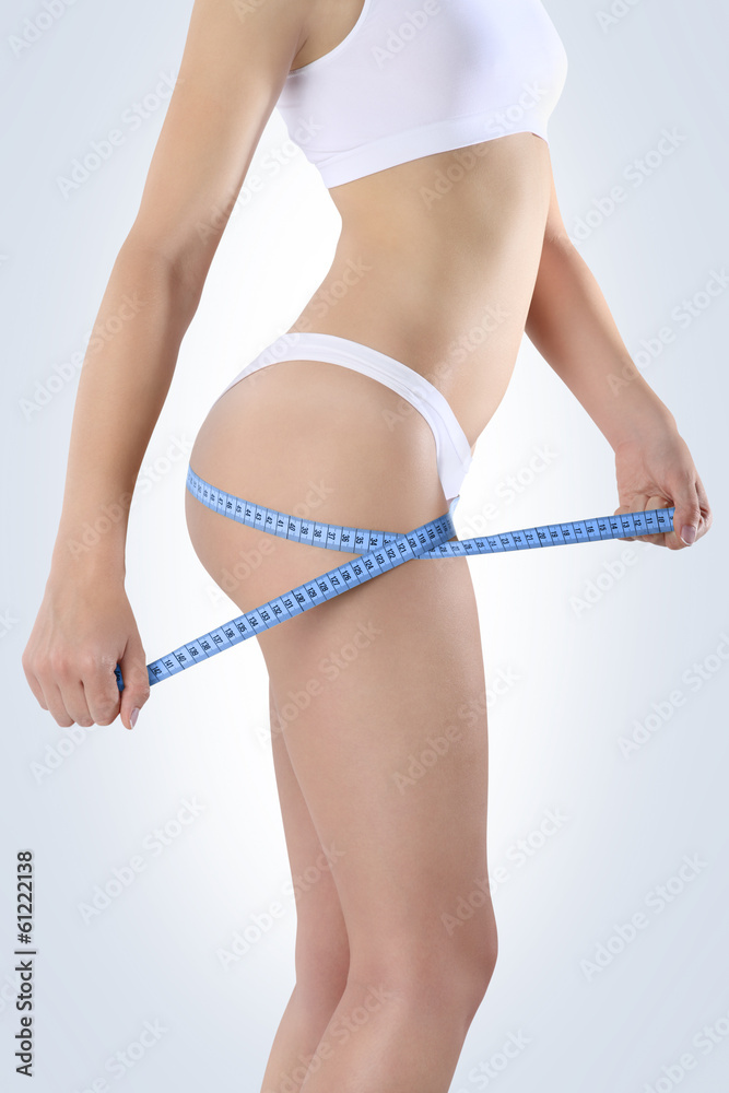 ass woman with meter for diet on a blue background