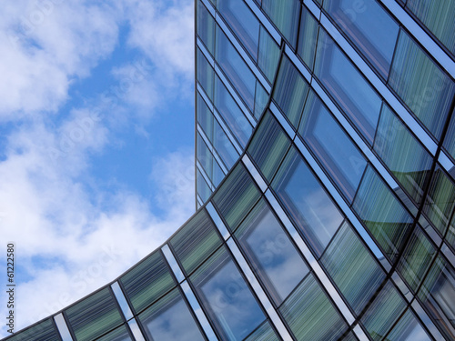 Angled shot of an office building with shiny blue glass