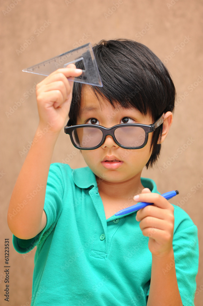 Asian schoolboy learning geometry Asian schoolboy learning geometry