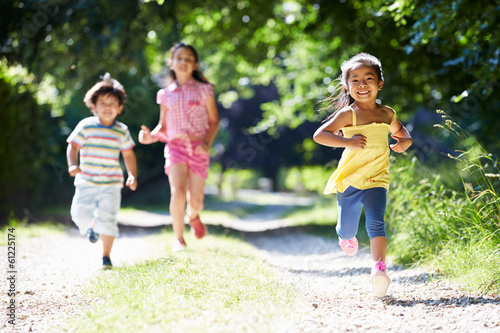 Three Asian Children Enjoying Walk In Countryside