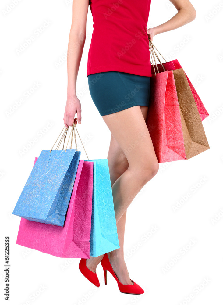 Female in red shoes holding shopping bags isolated on white