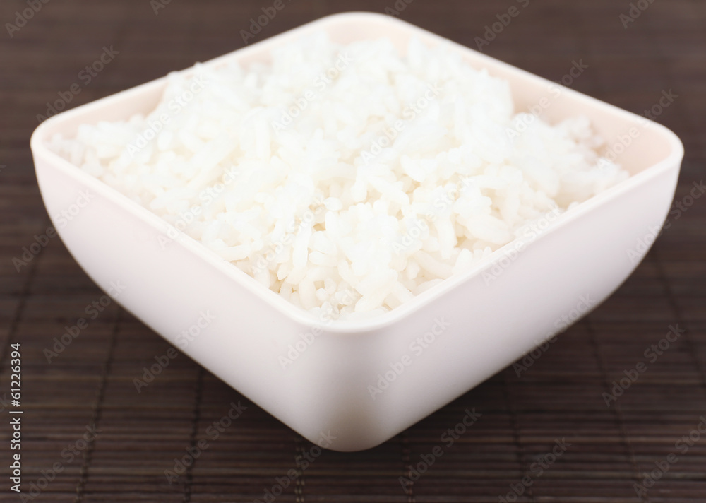 Cooked rice in bowl on bamboo background Cooked rice in bowl on bamboo background