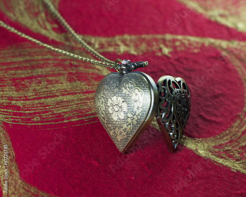 Close up of Heart Clock necklace on memories themes background