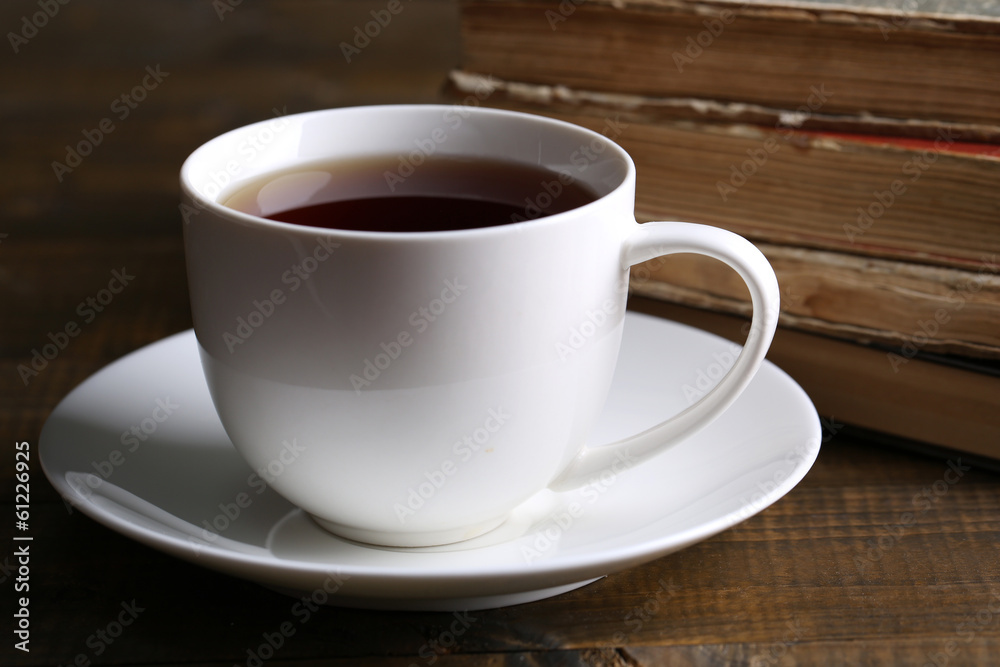 Cup of hot tea with books on table close up Cup of hot tea with books on table close up