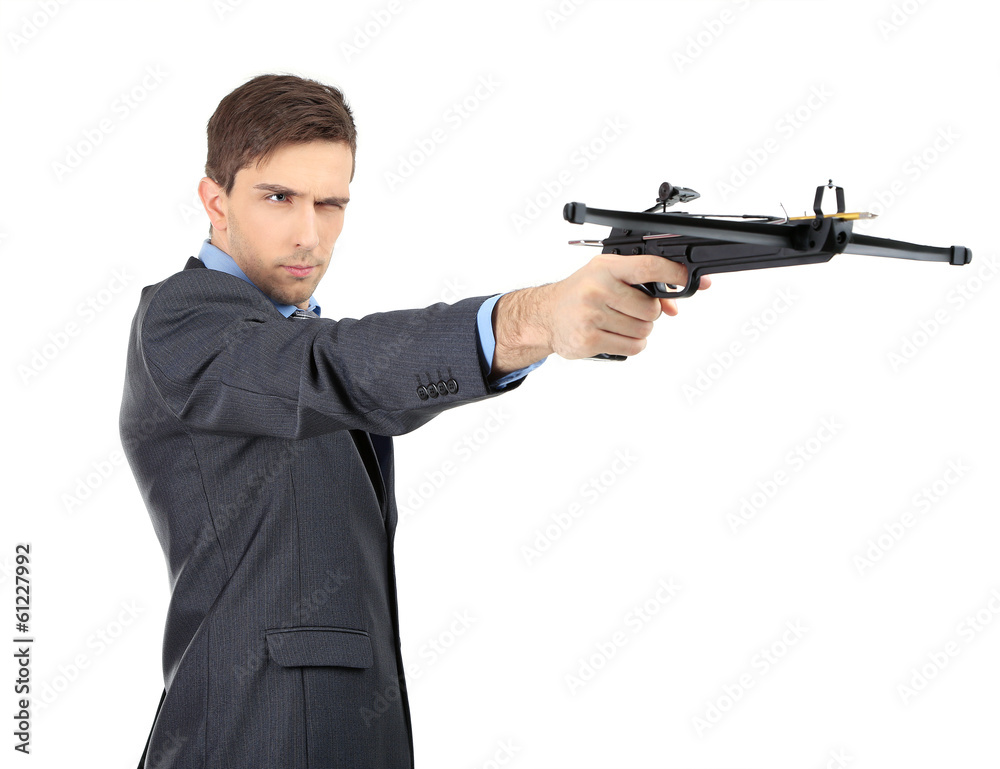 Young businessman with crossbow, isolated on white Young businessman with crossbow, isolated on white