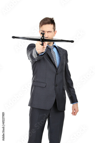 Young businessman with crossbow, isolated on white © Africa Studio