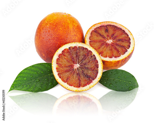 Blood oranges with cut and green leaves isolated on white backgr