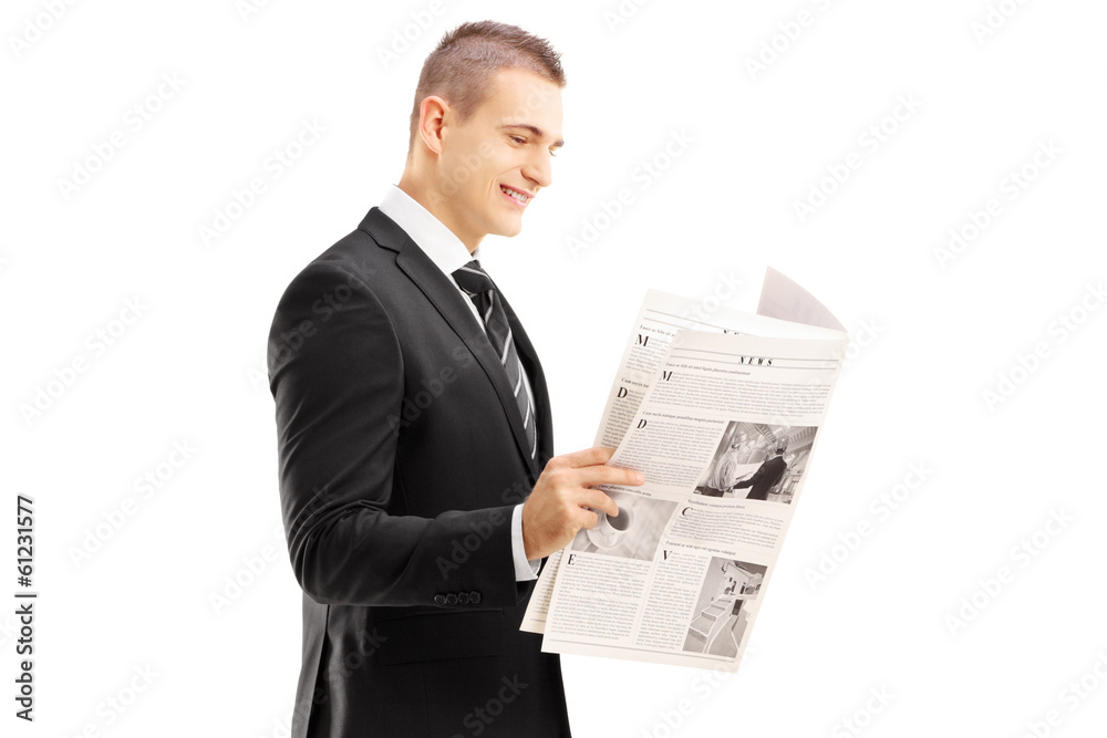 Young businessman reading a newspaper Young businessman reading a newspaper