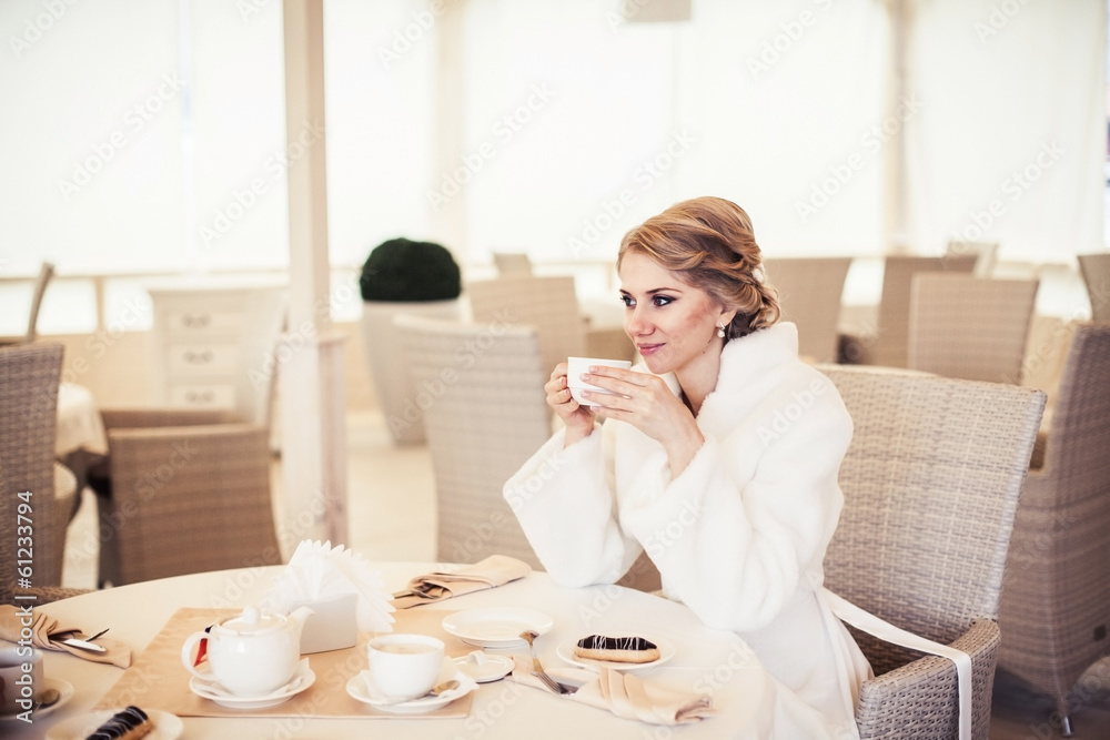 wedding. beautiful bride sitting in a cozy cafe in beige scenery wedding. beautiful bride sitting in a cozy cafe in beige scenery