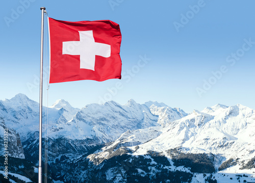 Swiss Flag Flying Over Alpine Scenery photo