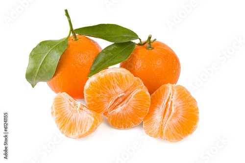 Two mandarines or tangerines with leaves and peeled one