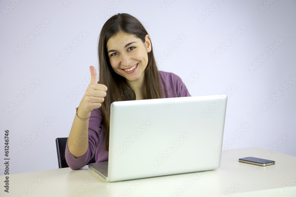 Happy woman working with computer thumb up Happy woman working with computer thumb up