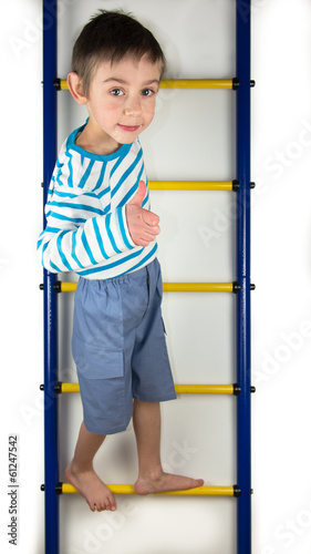 A child stands on a ladder on white background