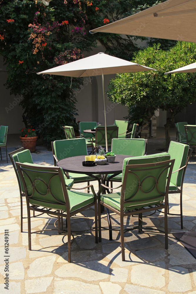 Iron tables and chairs in beautiful patio Iron tables and chairs in beautiful patio