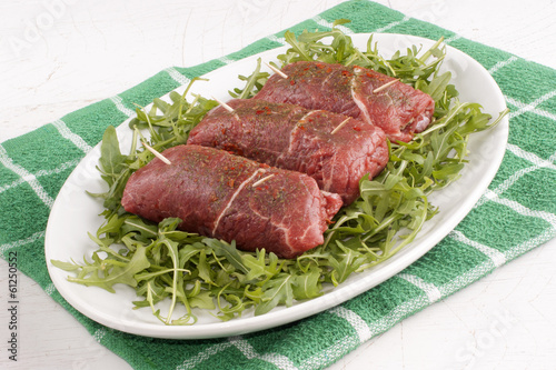 meat rolls on organic rocket salad