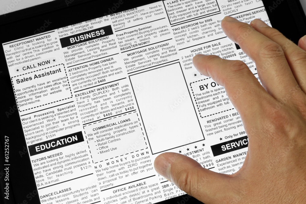 Obraz premium Touchpad and newspaper
