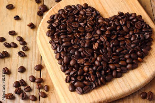 Coffee beans heart on wooden board