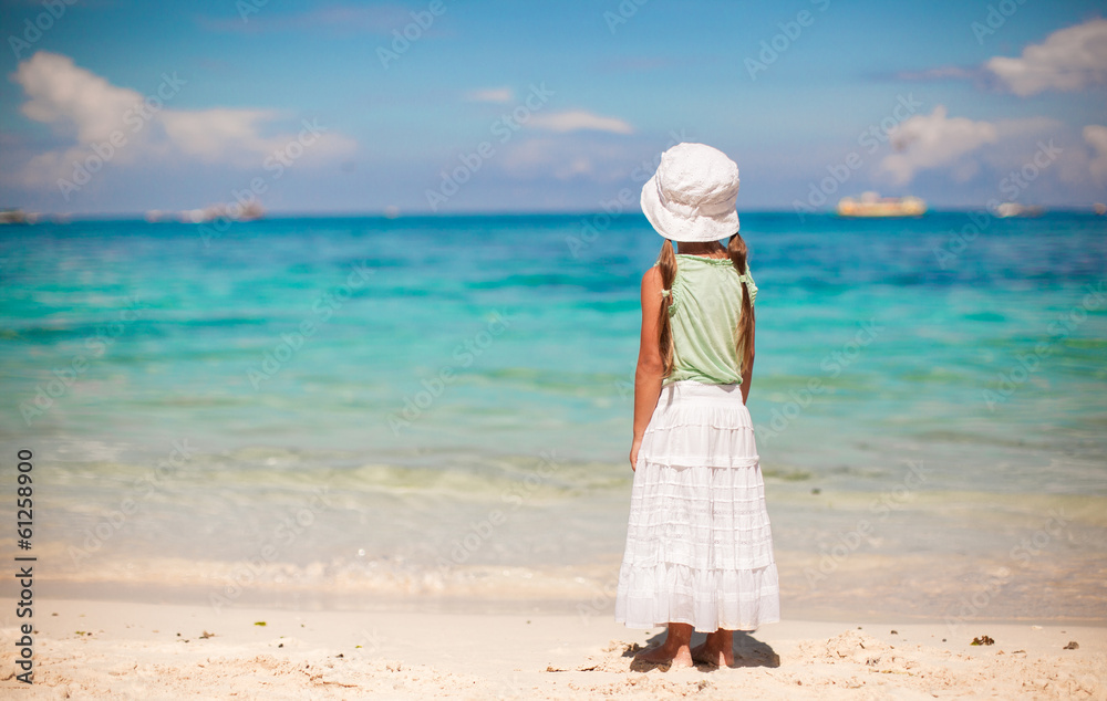 Adorable little girl walking on tropical white beach Adorable little girl walking on tropical white beach