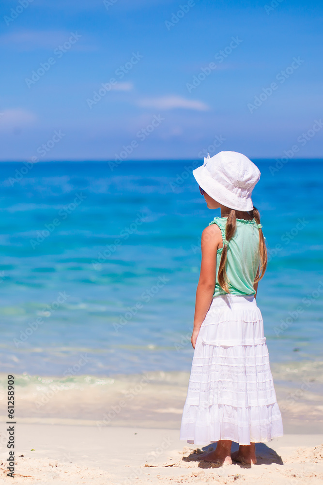 Back view of adorable little girl on tropical beach Back view of adorable little girl on tropical beach
