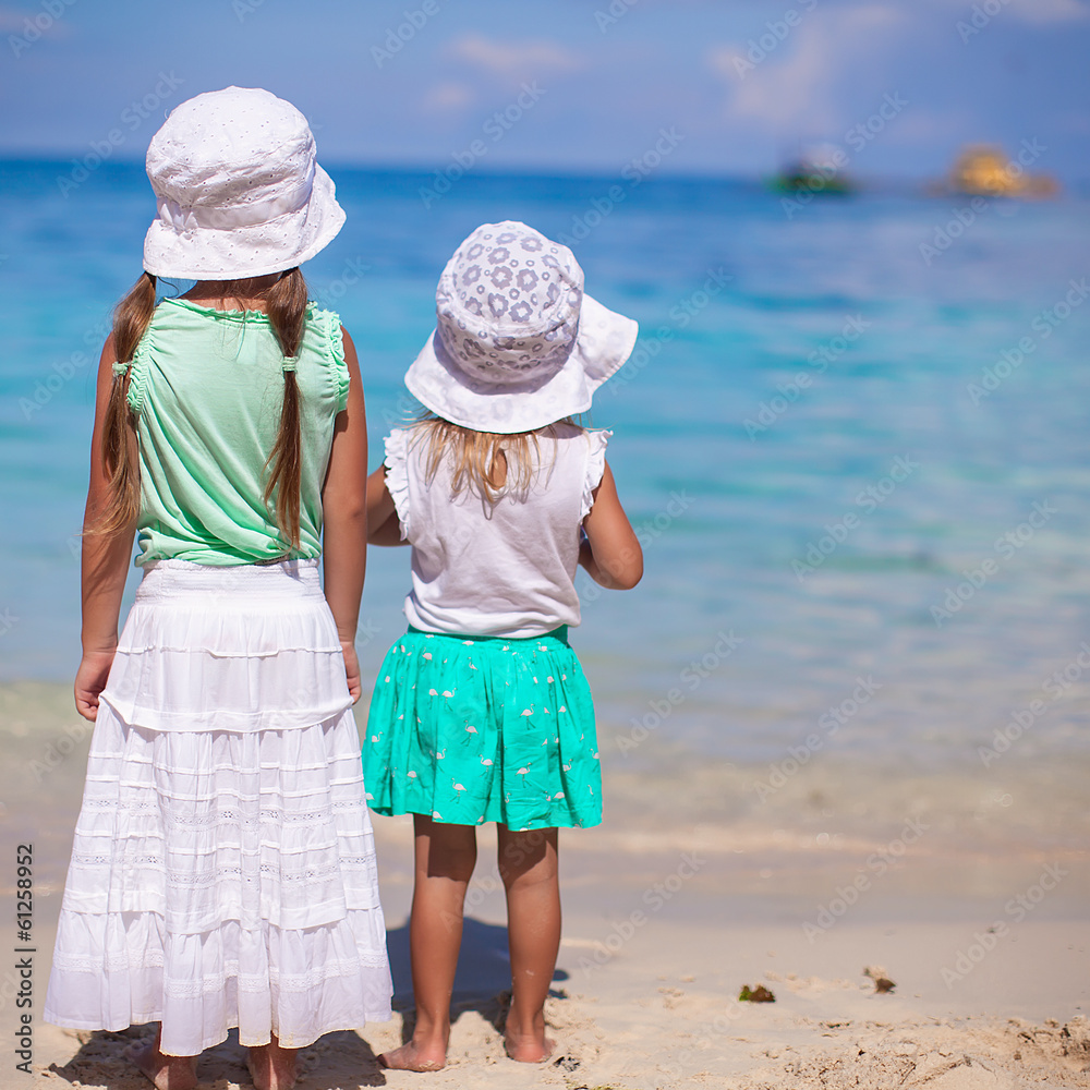 Little adorable girls in nice dress on white beach Little adorable girls in nice dress on white beach