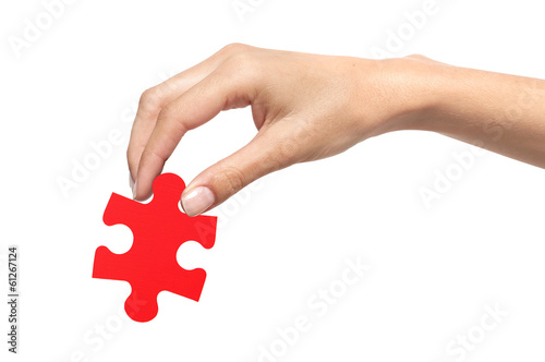 Red puzzle with woman hand isolated on white