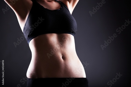 Woman wet sporty belly after exercise