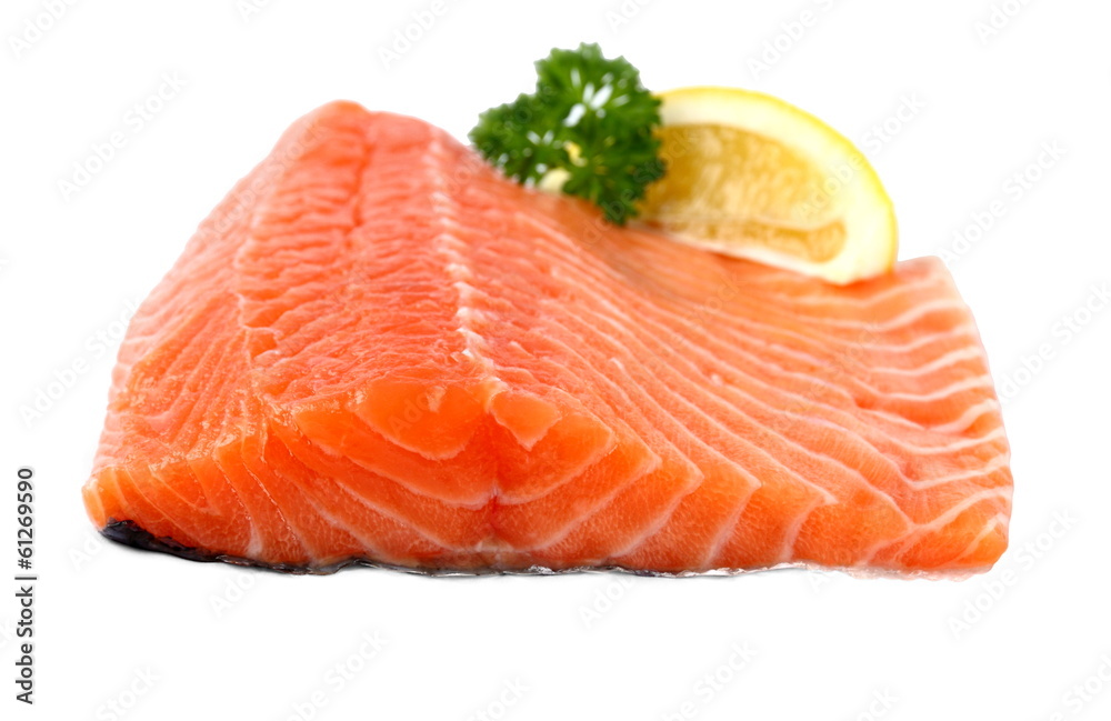Raw, red salmon fillet with lemon wedge