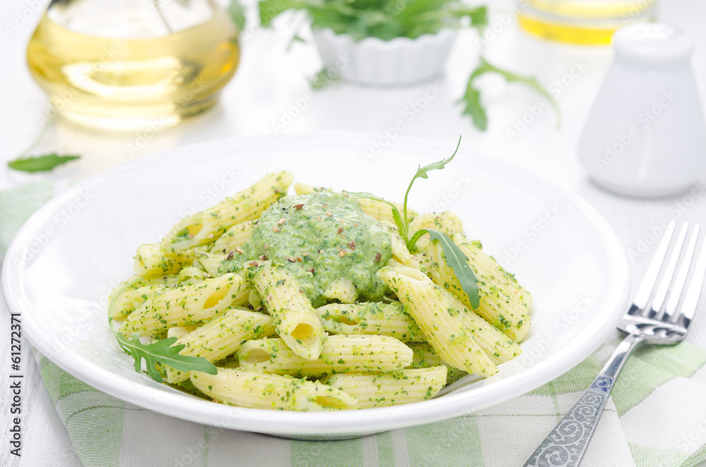 pasta penne with sauce of arugula and peas