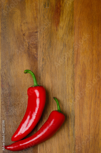 red hot chili peppers on a wooden background, vertical