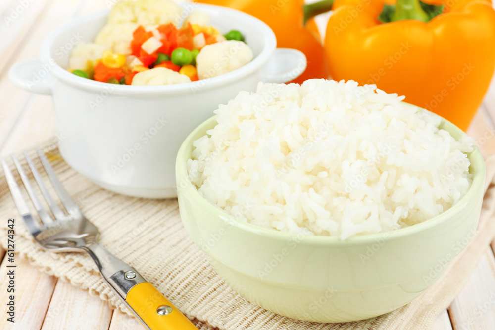 Cooked rice with vegetables on wooden table close up Cooked rice with vegetables on wooden table close up