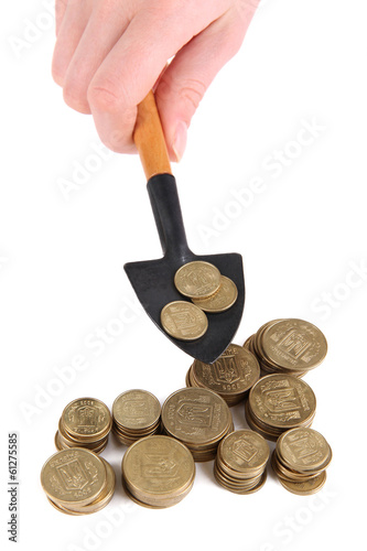 Cuadro en lienzo Hand holding shovel with coins isolated on white