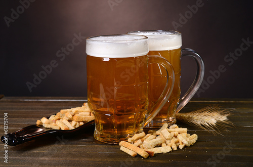 Fototapeta Naklejka Na Ścianę i Meble -  Glasses of beer with snack on table on dark background